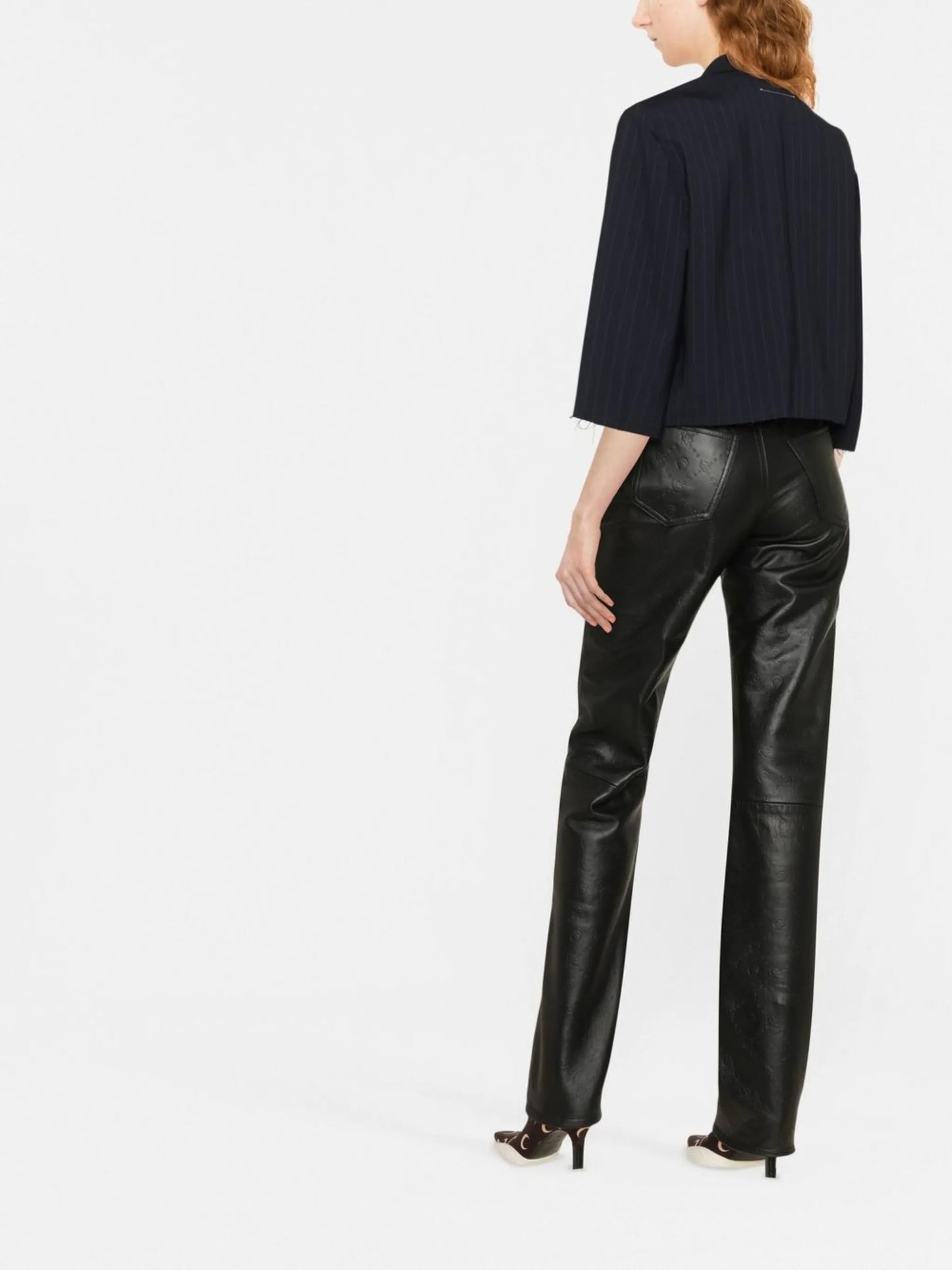all-over embossed-logo leather trousers