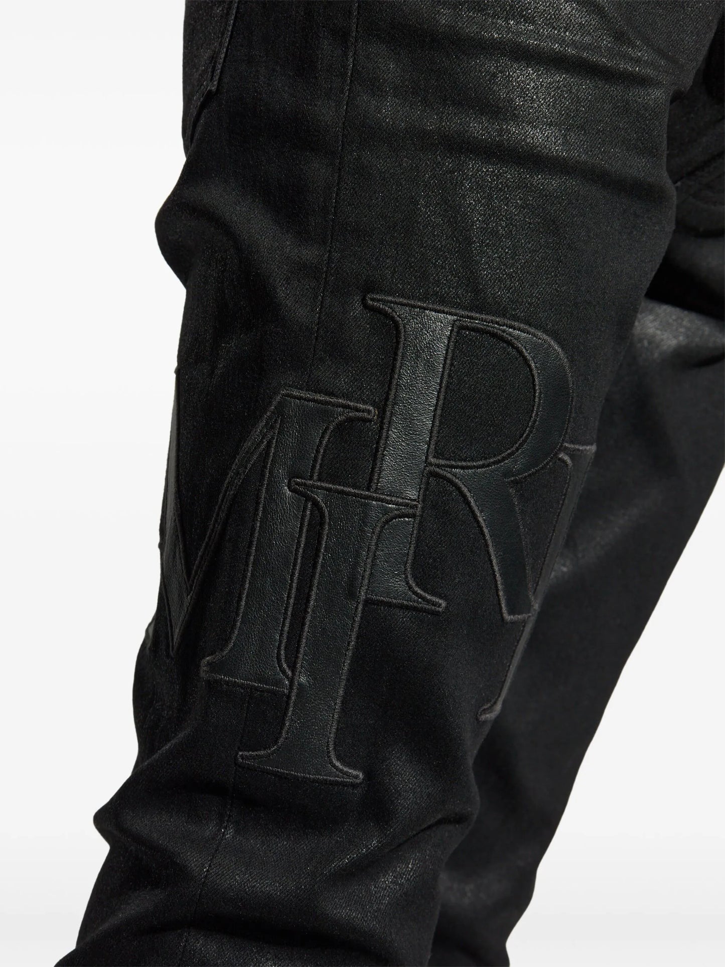 waxed staggered logo skinny jeans