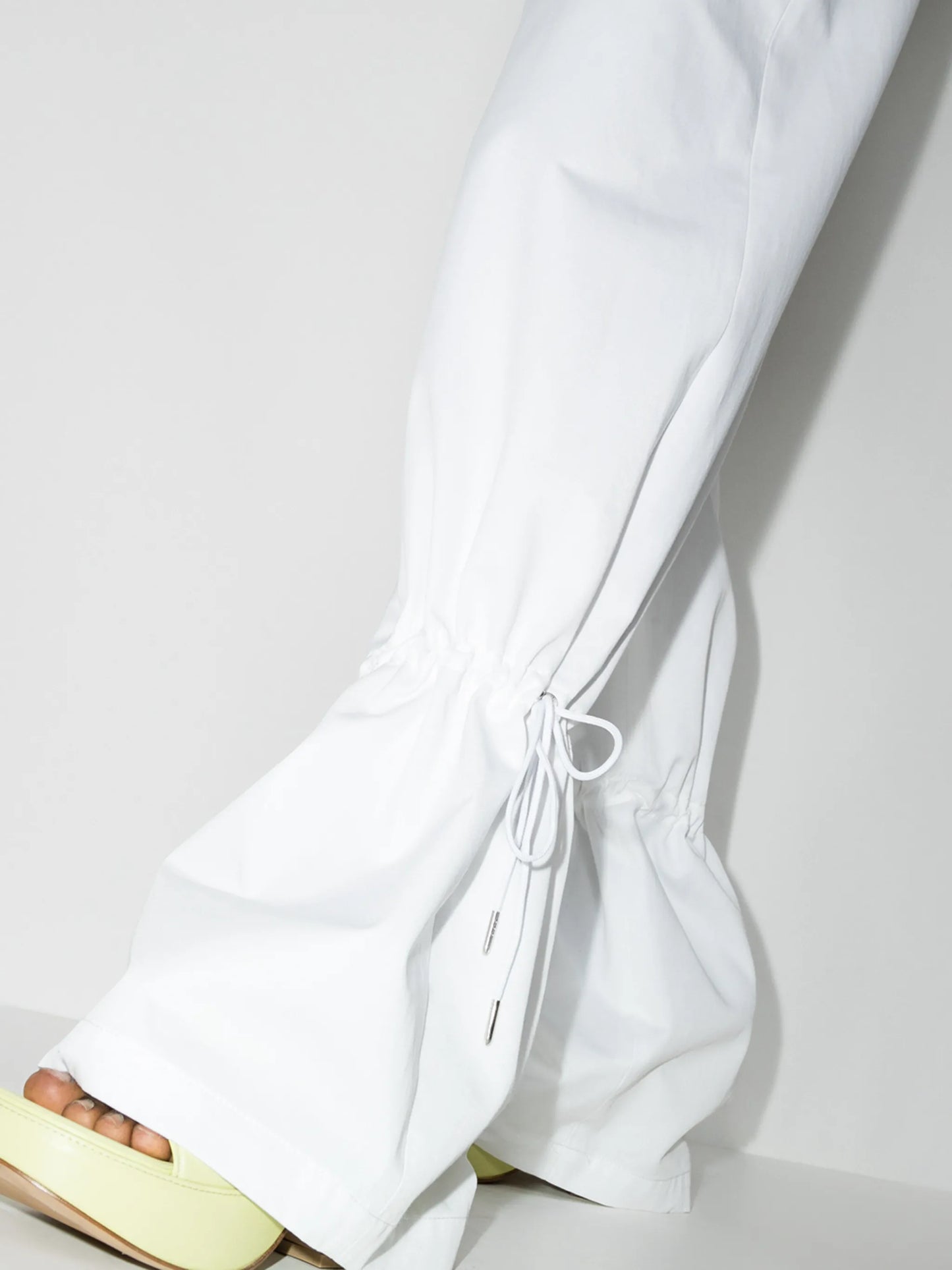 Eyelet tie-cuff flared trousers