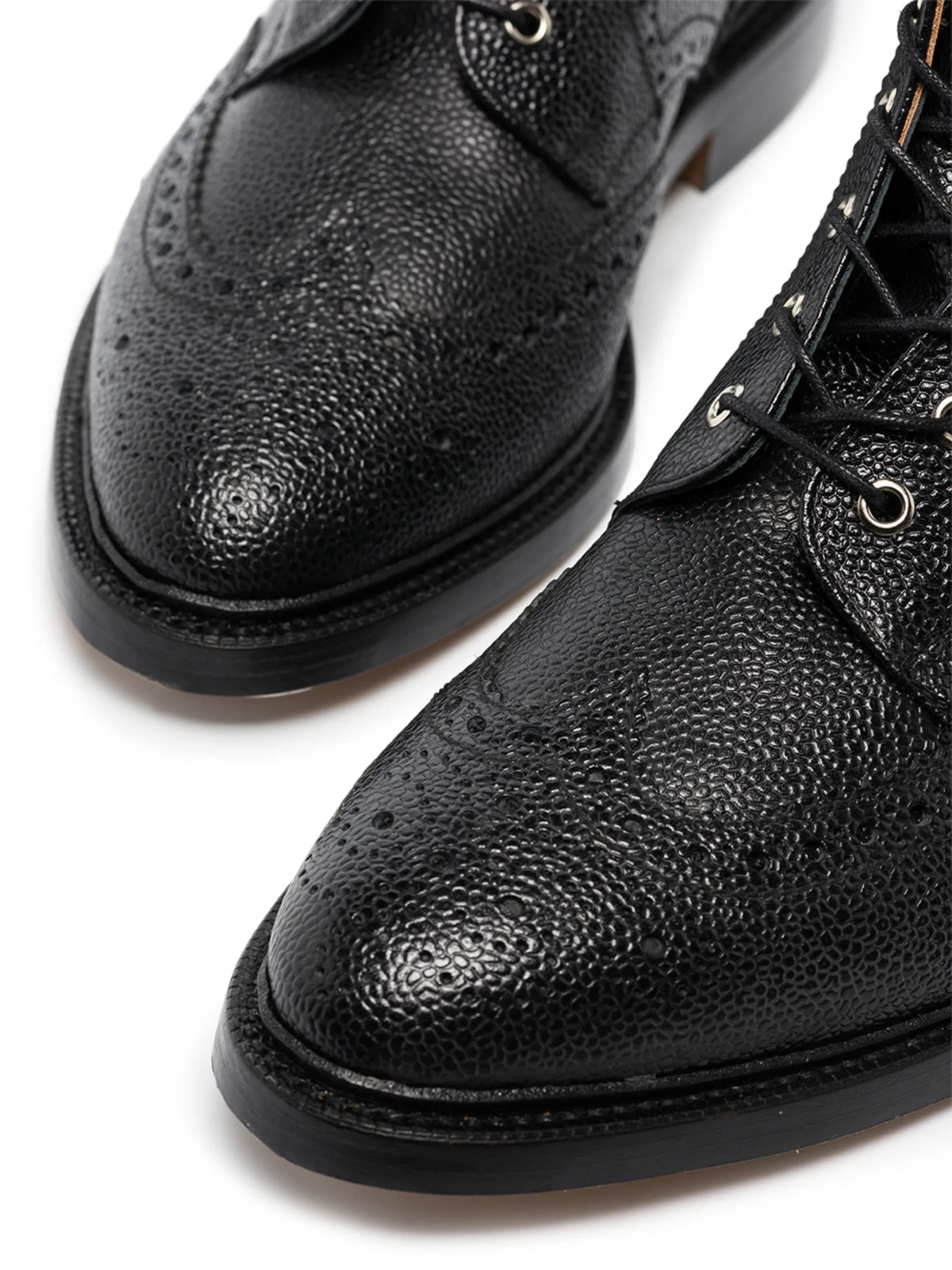 pebble grain leather wingtip boots with metal taps
