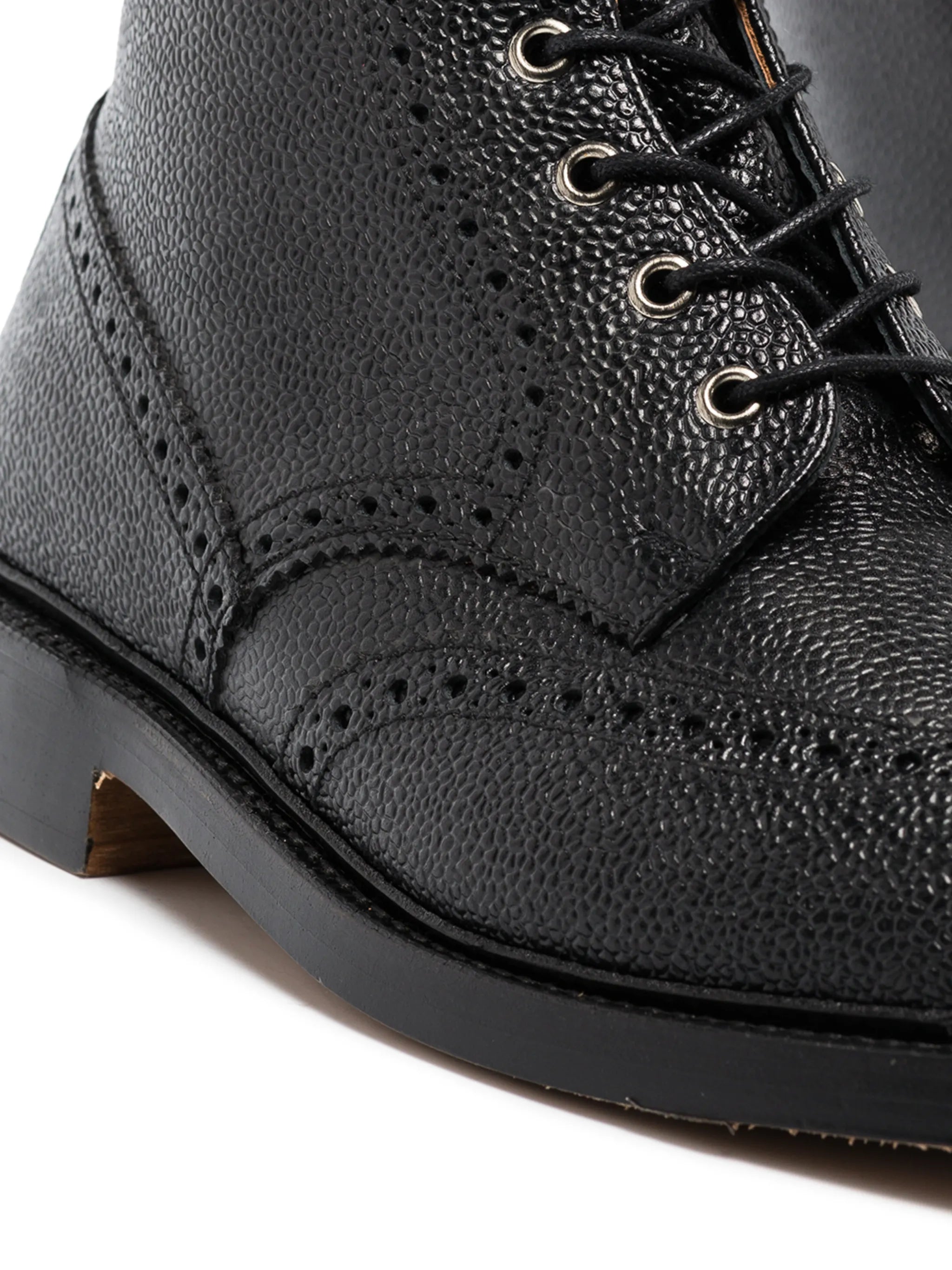 pebble grain leather wingtip boots with metal taps