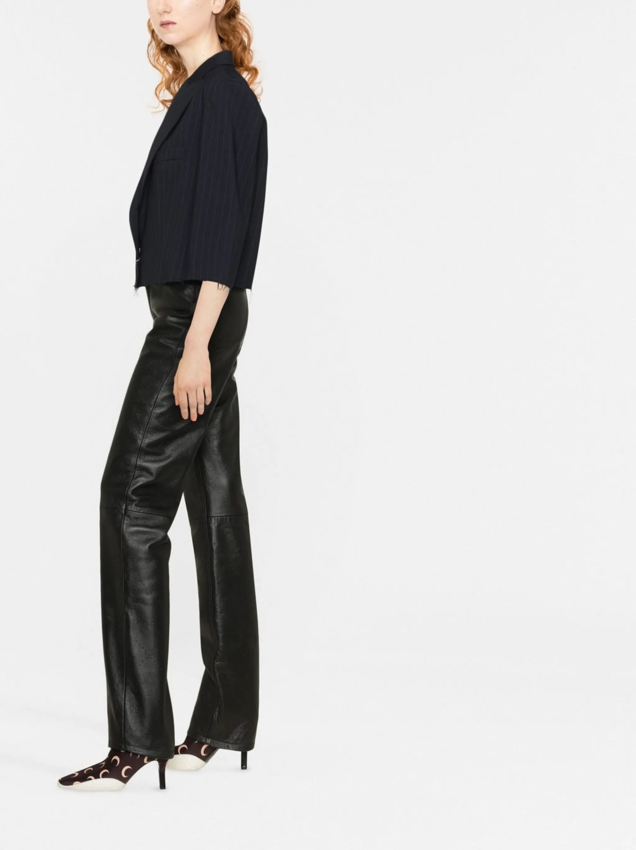 all-over embossed-logo leather trousers