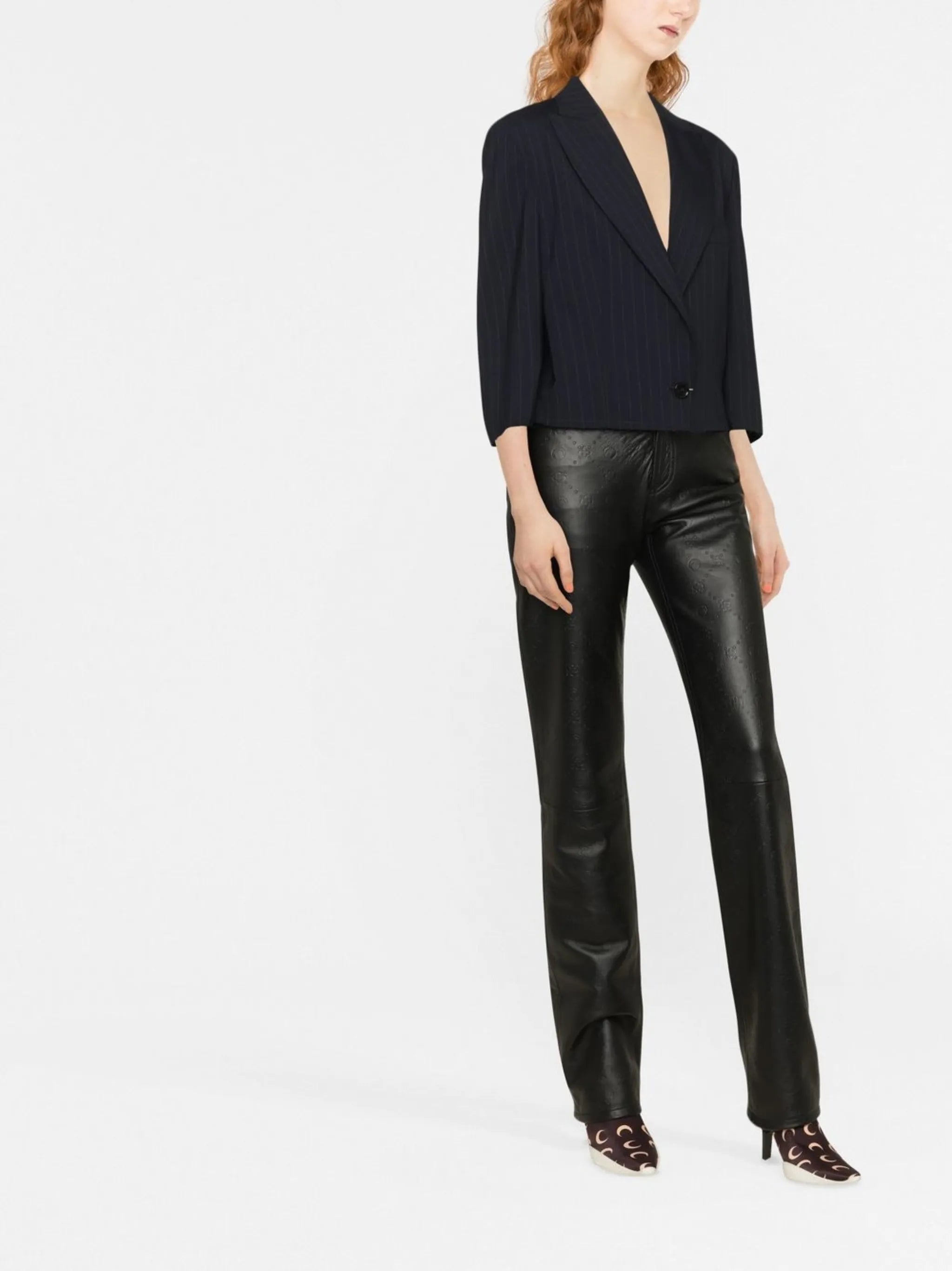 all-over embossed-logo leather trousers