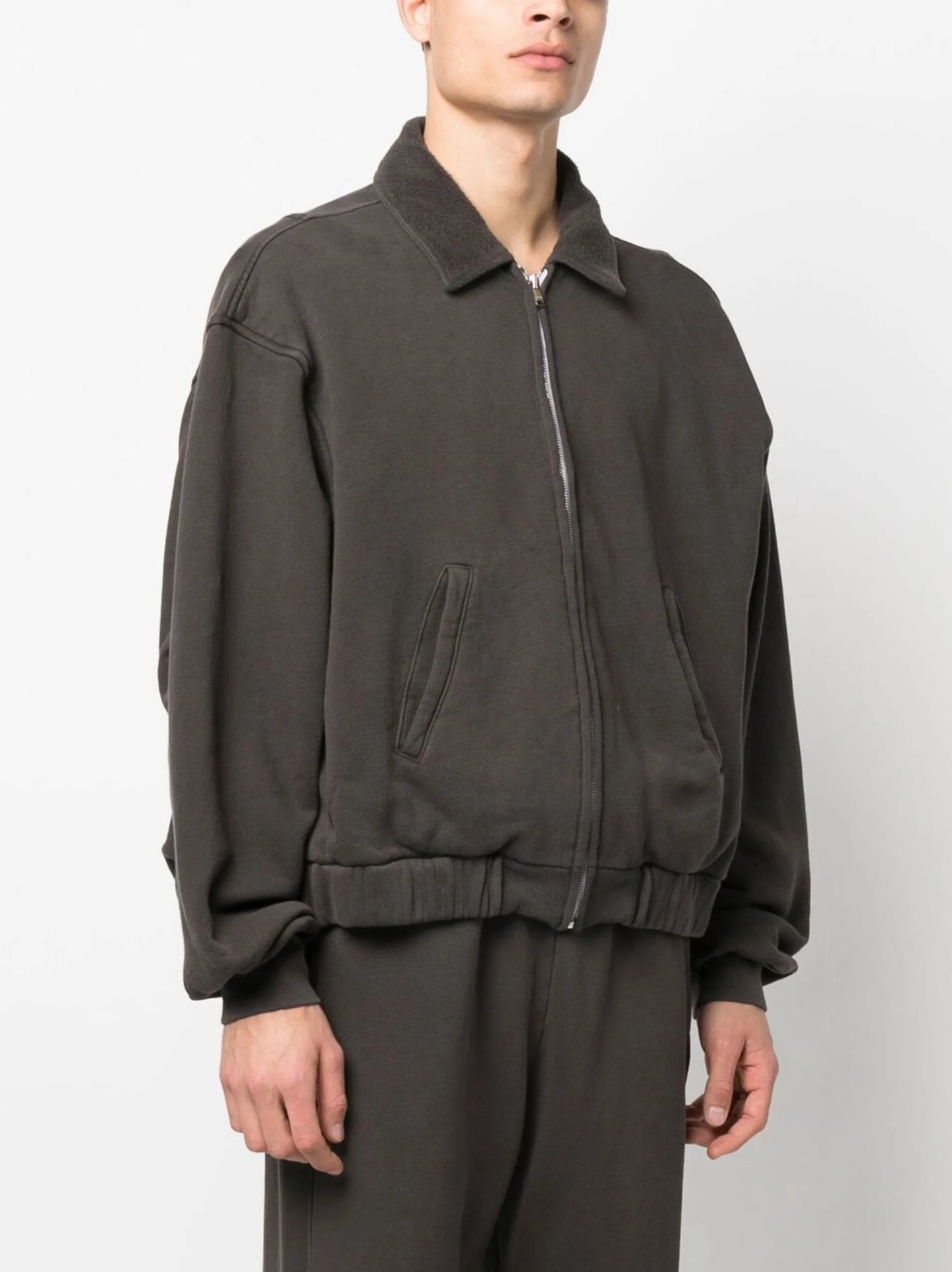 zipped-up sweat jacket