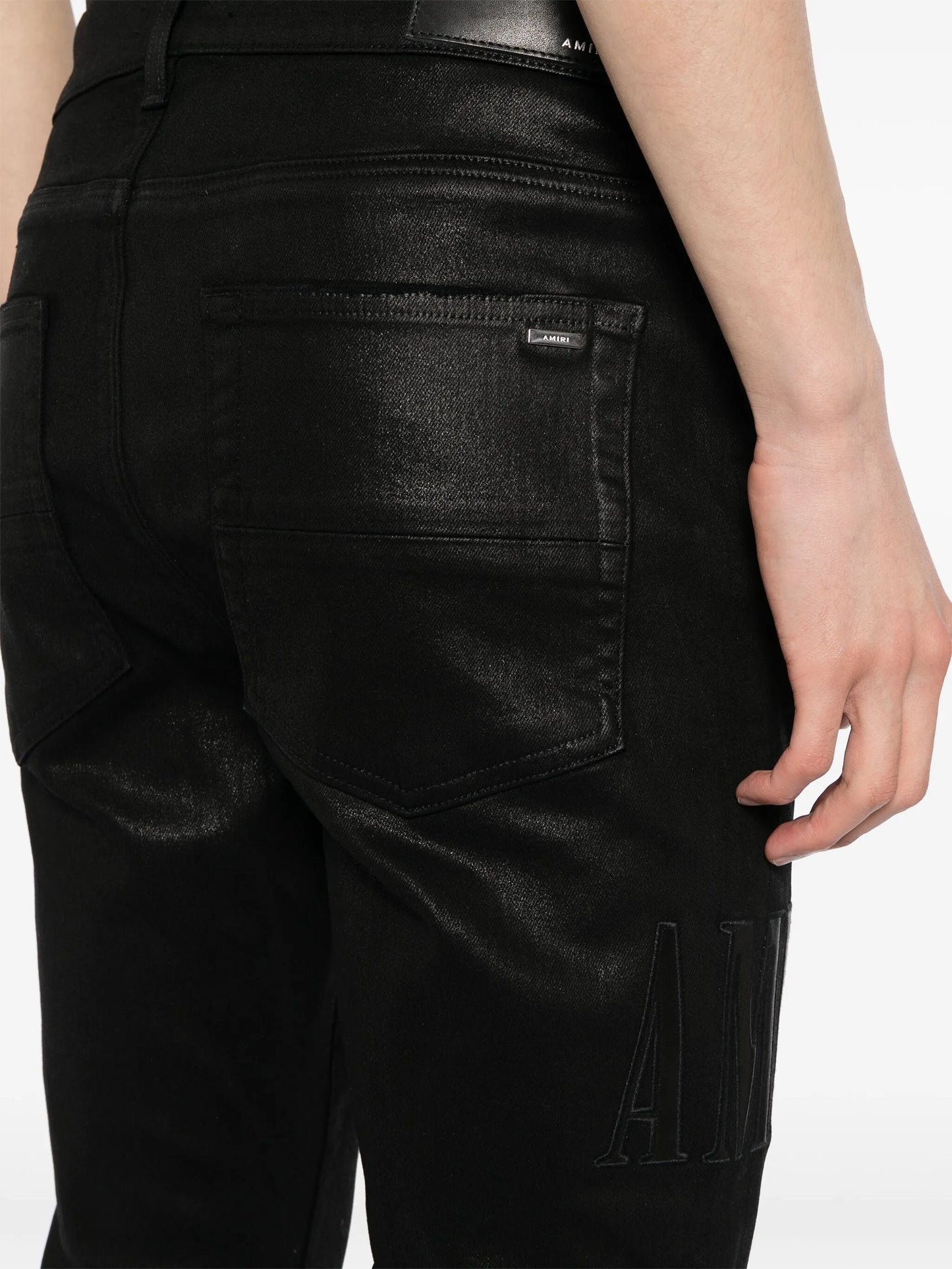 logo-embroidered distressed slim-cut jeans