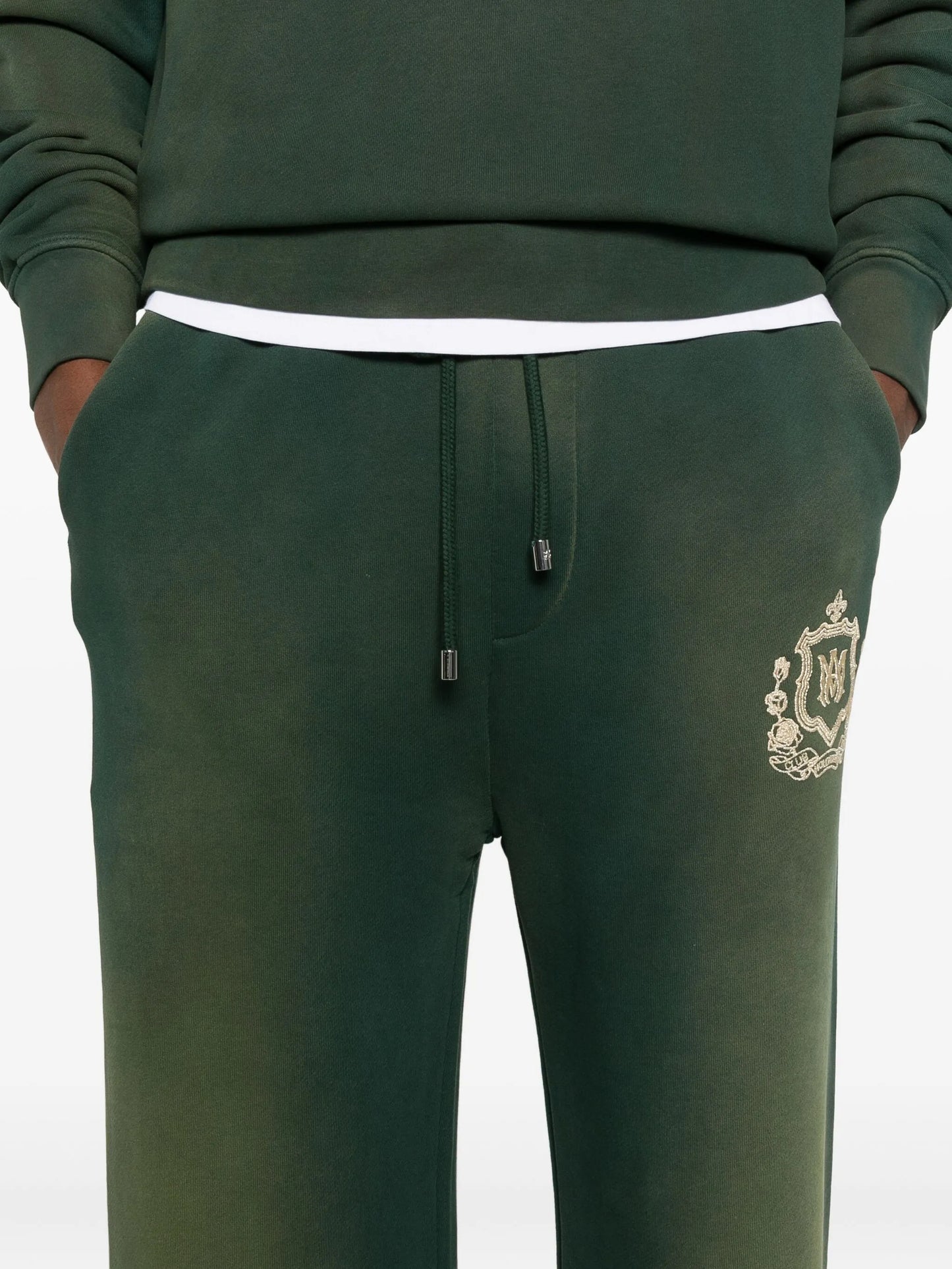 crest-embellished track pants