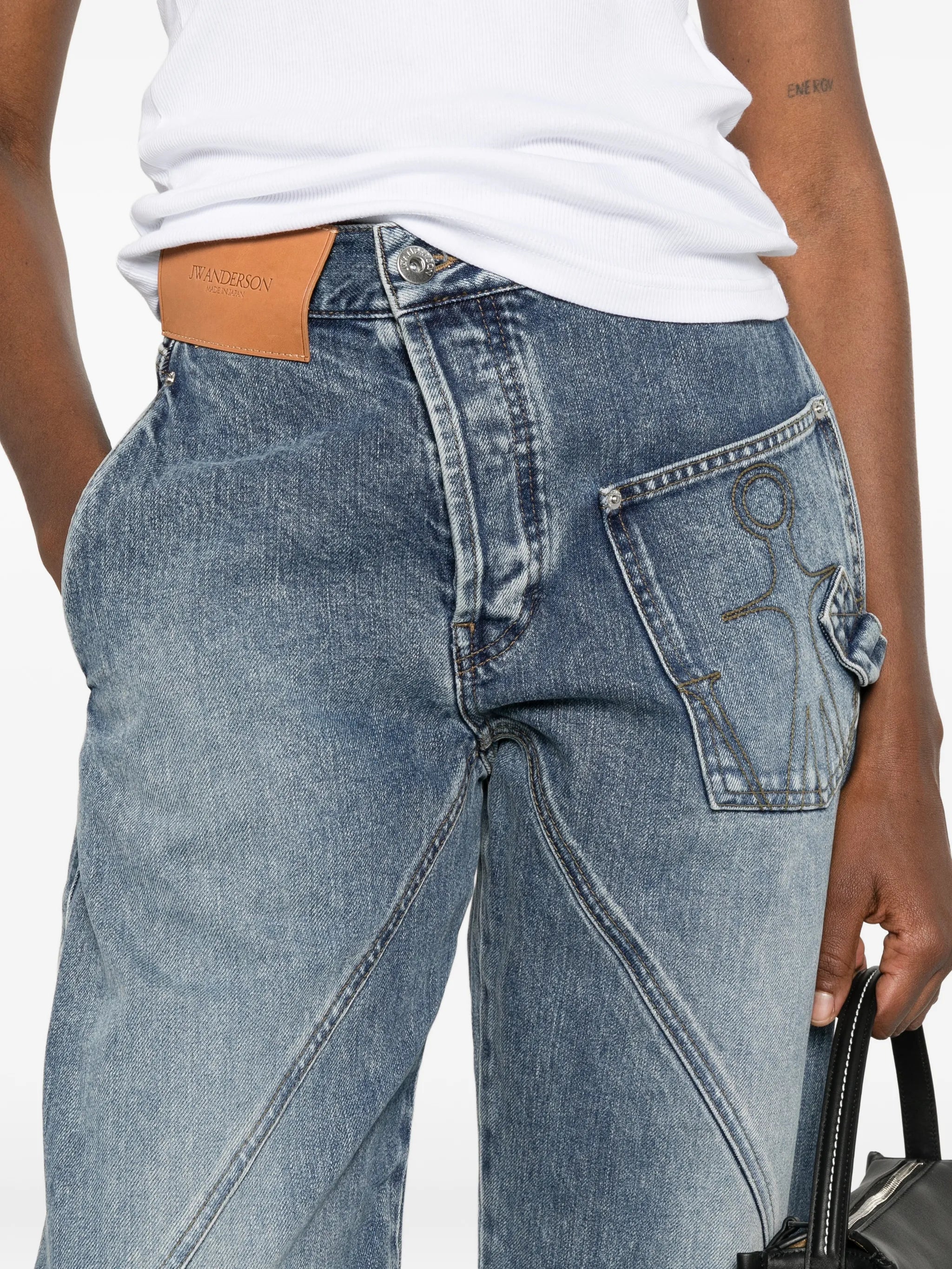 twisted-effect logo-patch jeans