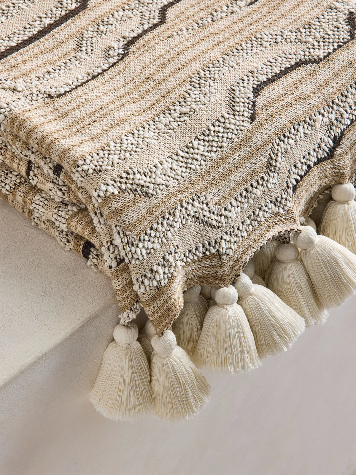 Cloud knitted tassel-detail throw