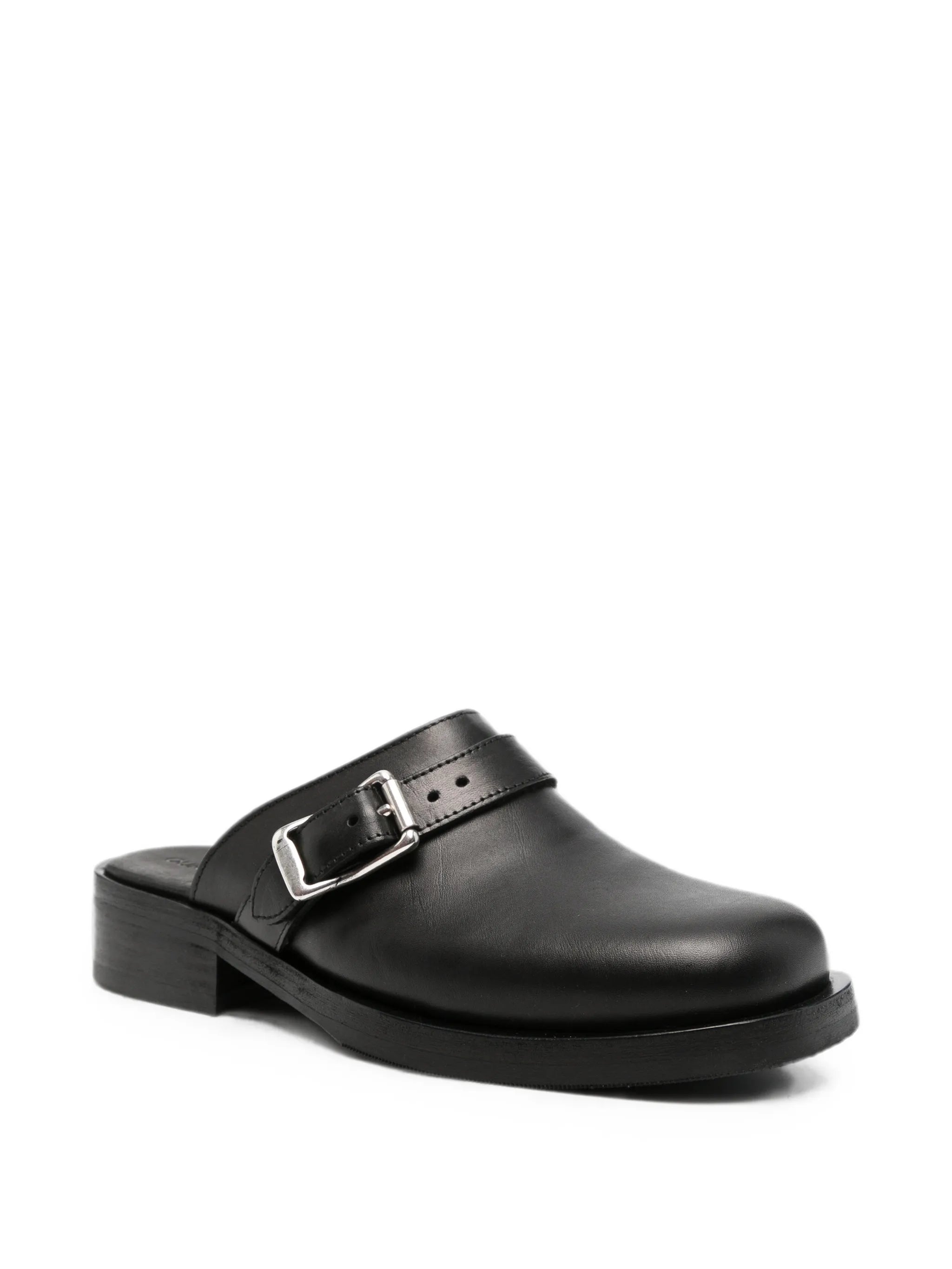 Camion mules in black leather