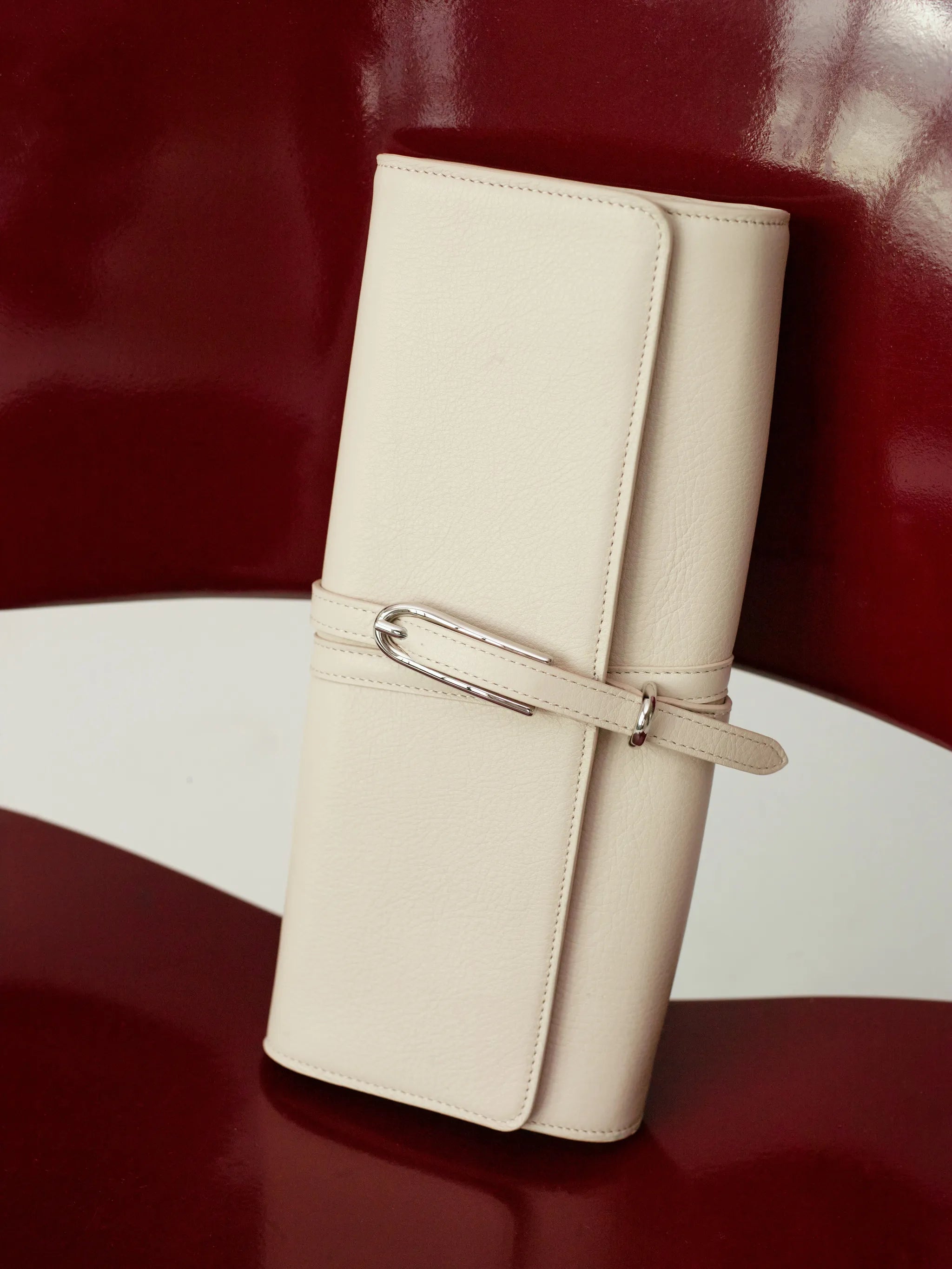 belted leather clutch bag