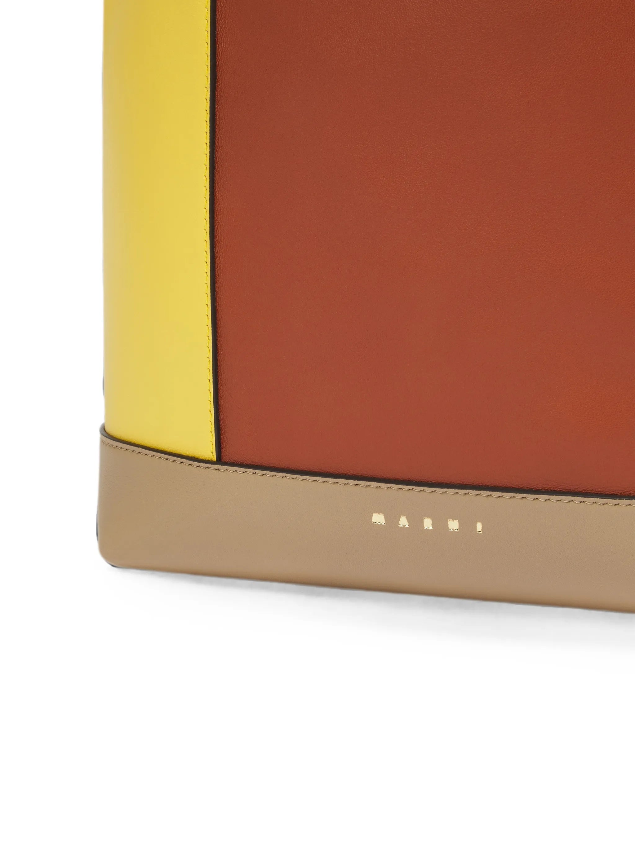 yellow, brown and taupe leather Pod 2.0 bag